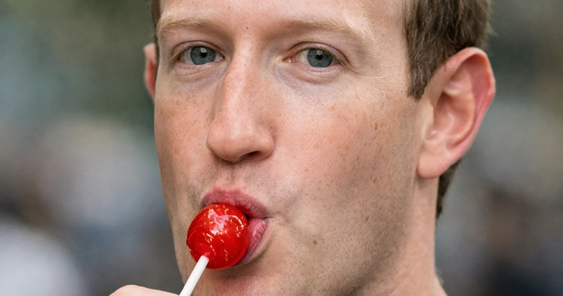 A picture of Mark Zuckerberg sucking on a lollipop.